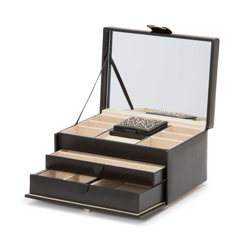 The WOLF 1834 Marrakesh Black Jewellery Box boasts an open design featuring a large mirror in the lid, elegantly embellished with leather and gold studding. Inside, you'll discover multiple compartments and two pull-out drawers lined with beige fabric, accompanied by a small, decorated jewelry case.