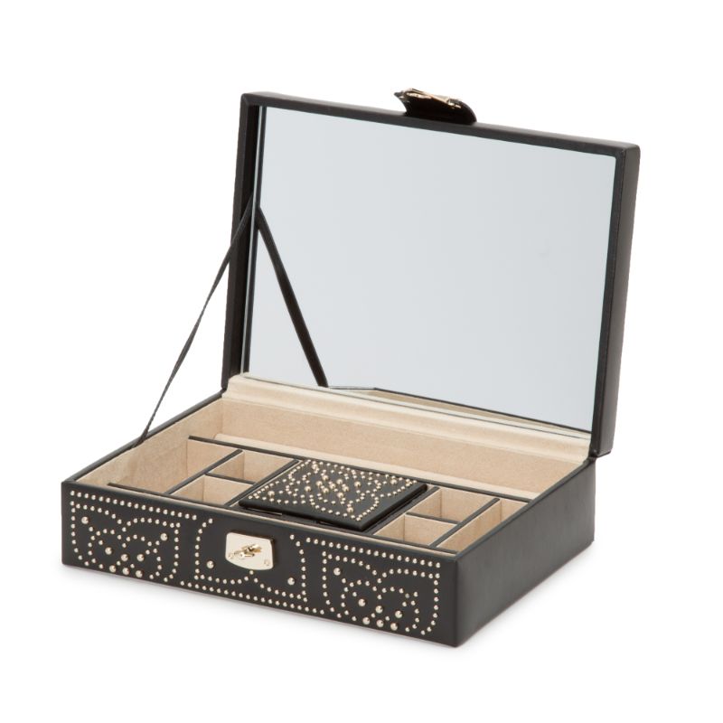 The WOLF 1834 Marrakesh Flat Jewellery Box by WOLF is a sophisticated open black leather case featuring a mirrored lid. It boasts a beige interior with compartments designed for organizing jewelry. The exterior is adorned with decorative heart-shaped patterns and gold stud embellishments, while the innovative LusterLoc™ lining protects your pieces from tarnishing.