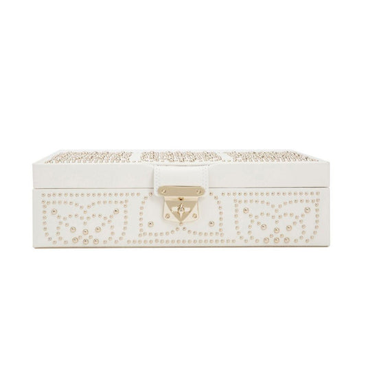 The WOLF 1834 Marrakesh Cream Jewellery Box is a white rectangular vanity case embellished with an elaborate gold studding pattern on the lid and sides, enhanced by LusterLoc™ technology. It features a luxurious gold-tone clasp at the front, seamlessly blending elegance with functionality.