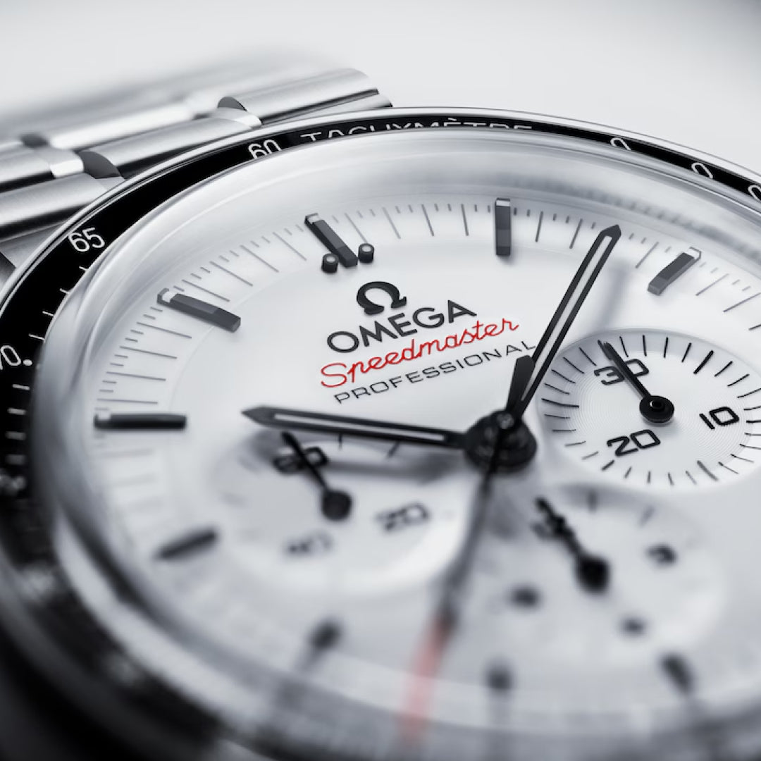 Close-up of the OMEGA Speedmaster Moonwatch Professional Co-Axial Master Chronometer Chronograph 42mm, featuring detailed chronograph dials, a black tachymeter bezel, silver hour markers, and signature red “Speedmaster” text.