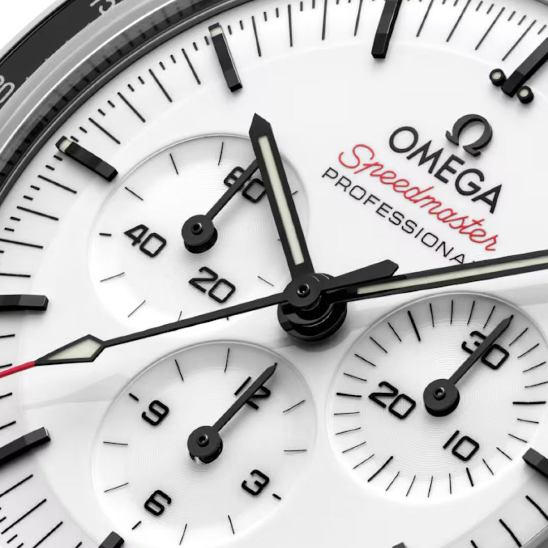 Close-up of the OMEGA Speedmaster Moonwatch Professional Co-Axial Master Chronometer Chronograph 42mm, featuring black indices, three subdials, and red "Speedmaster" text on a white dial with visible hour, minute, and second hands.