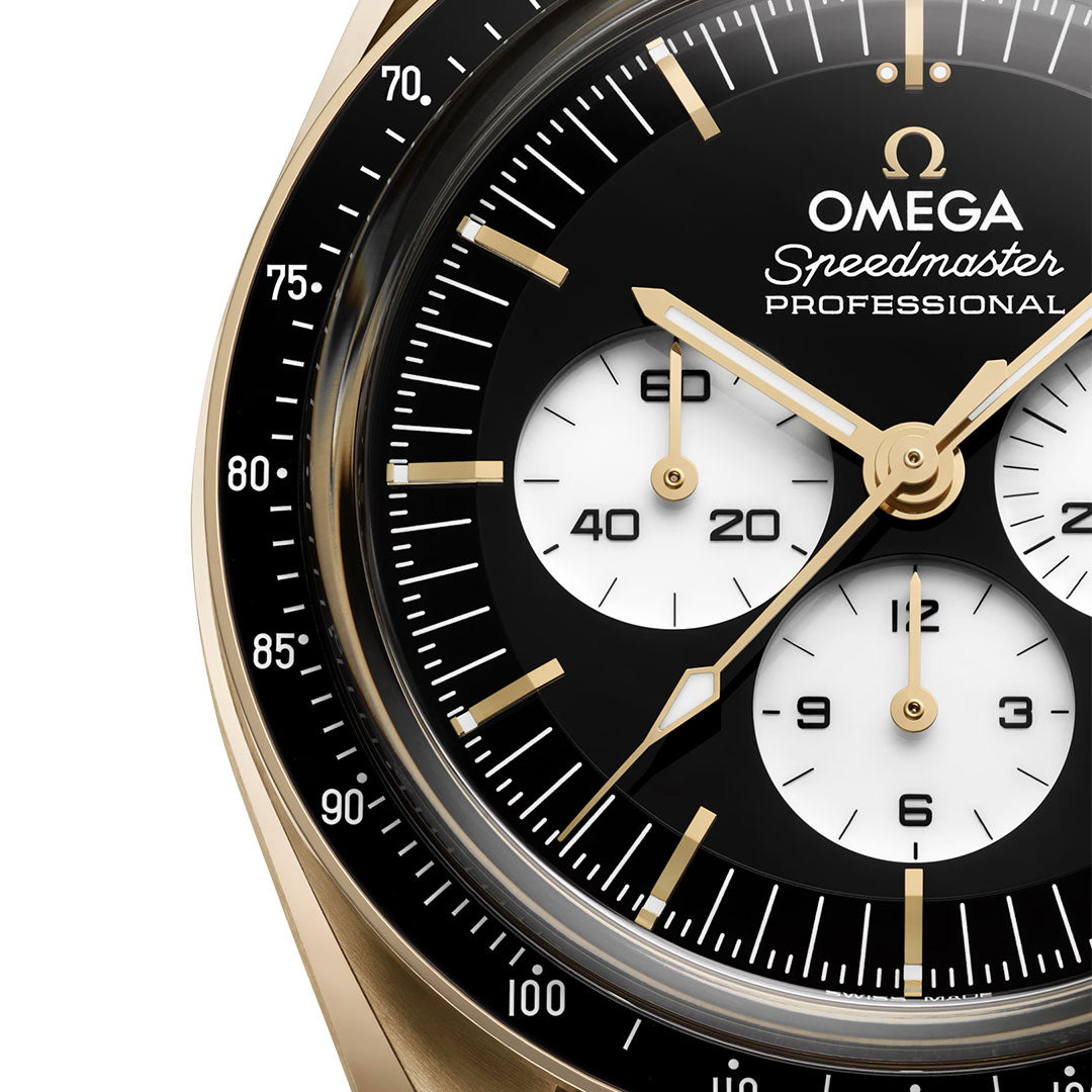 Close-up of the OMEGA Speedmaster Moonwatch Professional Co-Axial Master Chronometer Chronograph 42mm, featuring an 18K Moonshine™ Gold case, gold markers and hands, three white subdials, and a black tachymeter bezel.