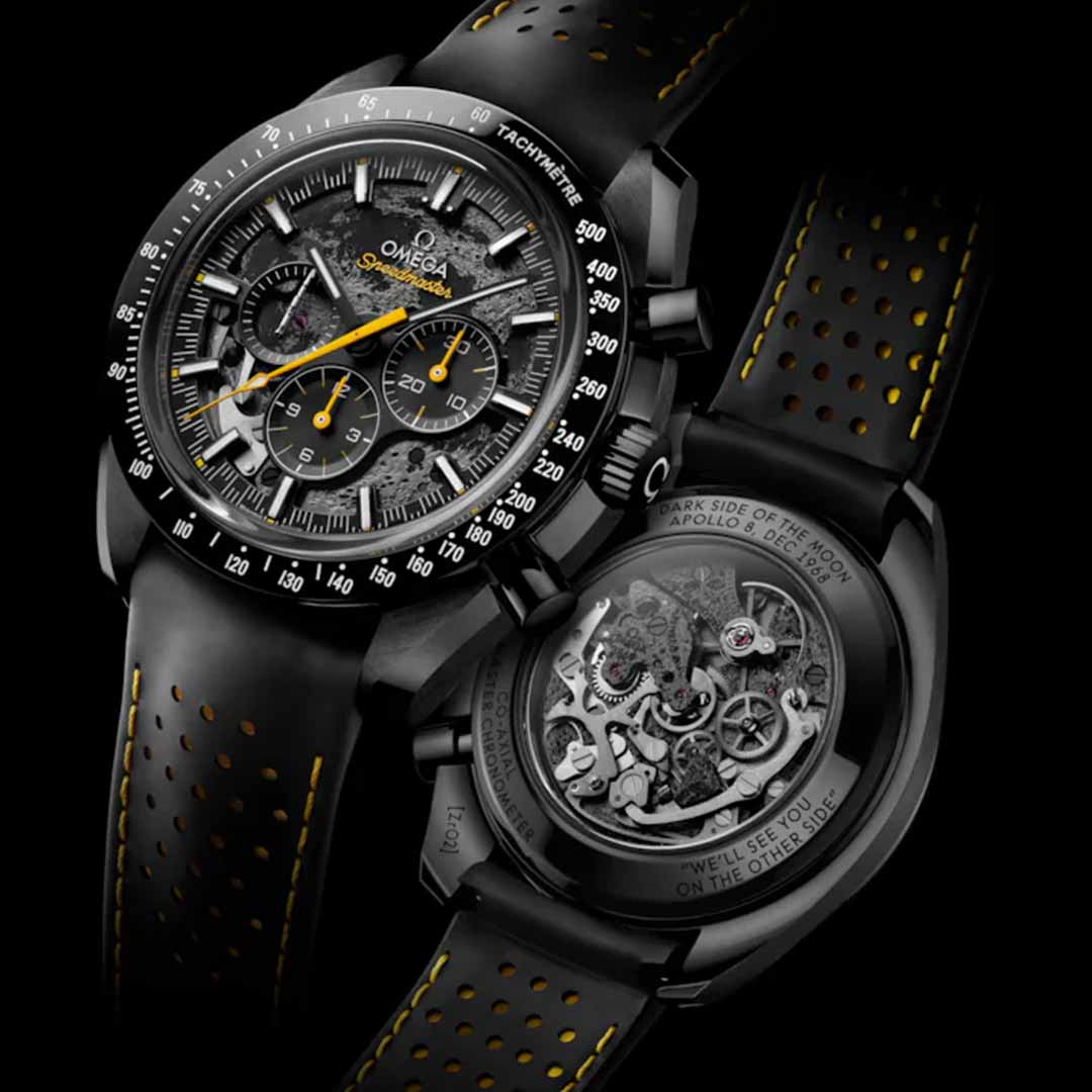 Close-up of the luxury OMEGA Speedmaster Dark Side of the Moon Co-Axial Master Chronometer 44.25mm Watch in black ceramic, featuring striking yellow accents. The front view showcases its intricate dial and chronograph elements, reminiscent of the iconic OMEGA Speedmaster from the moon landings. The back reveals its complex mechanical movements, highlighted against a dark background to emphasize its exceptional design and craftsmanship.