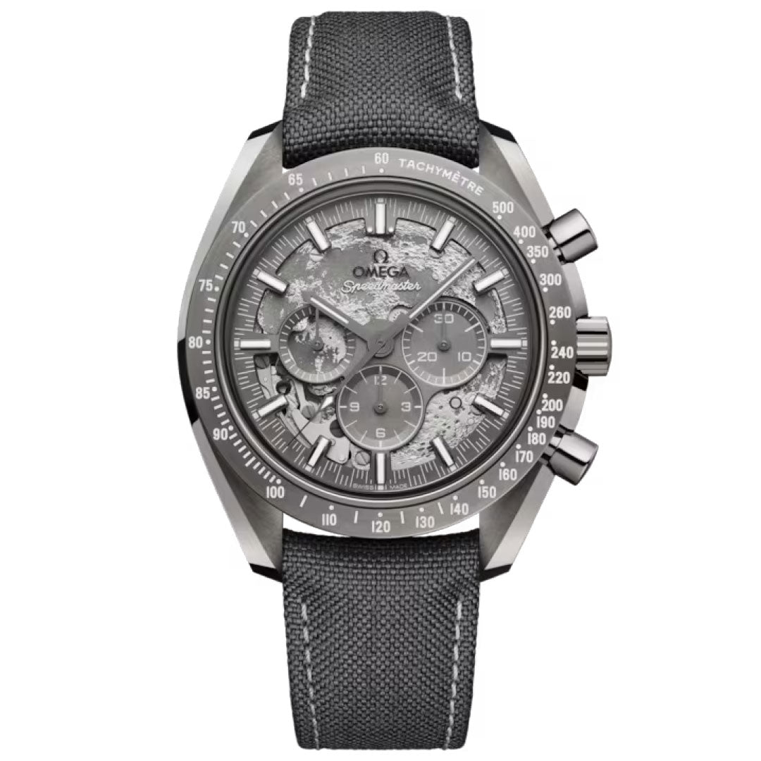The OMEGA Speedmaster Dark Side of the Moon Co-Axial Master Chronometer 44.25mm Watch features a textured grey dial, visible gears, silver hands and markers, black tachymeter bezel, and a dark grey fabric strap in bold grey ceramic.