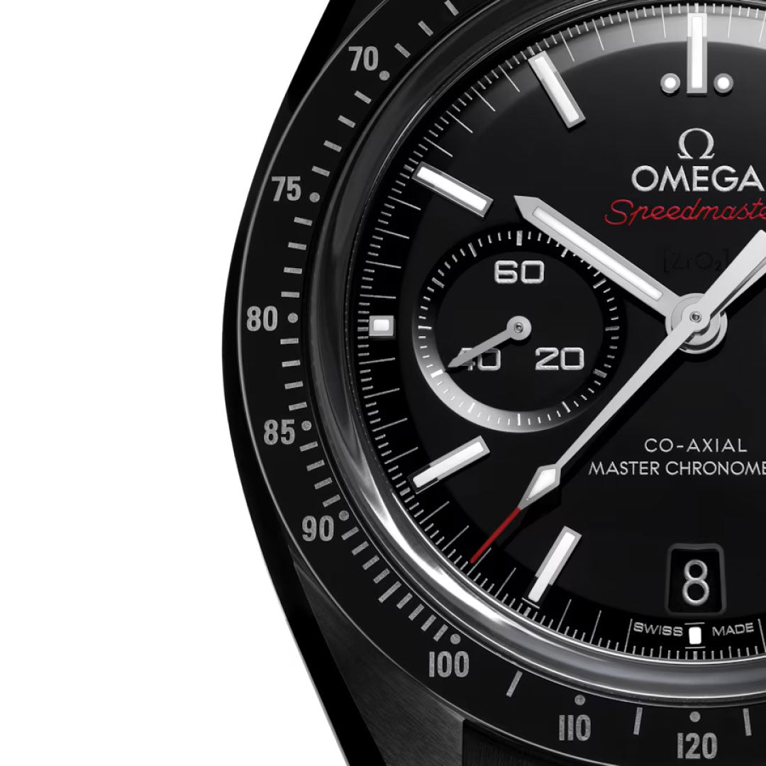 Close-up of the OMEGA Speedmaster Dark Side of the Moon Co-Axial Master Chronometer 44.25mm, showcasing a black ceramic dial, white and red hands, sub-dials, tachymeter bezel, date at 6 o'clock, and OMEGA logo.