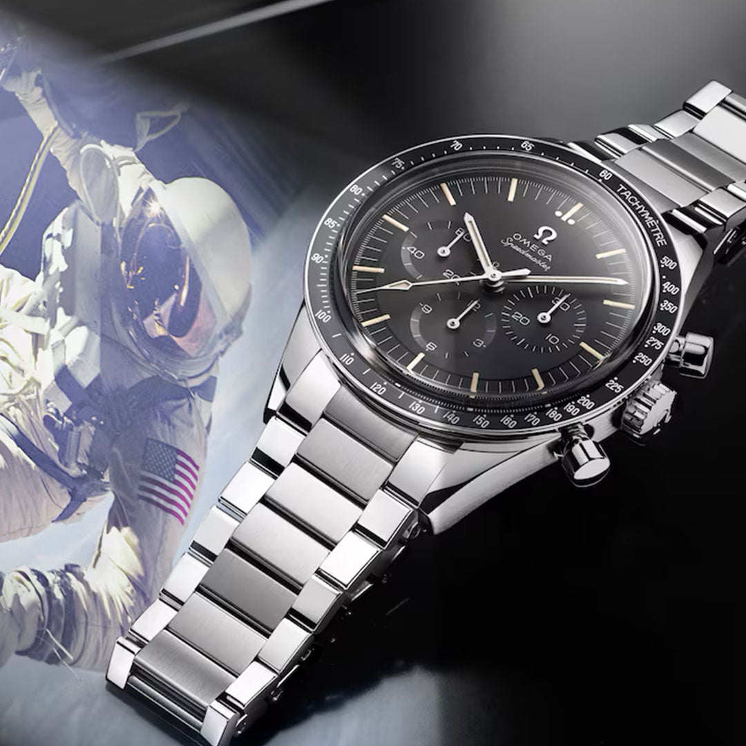 An OMEGA Speedmaster Calibre 321 Chronograph Manual-Winding 39.7mm watch with a black dial is displayed on a reflective surface beside a vintage astronaut photo, showcasing its iconic movement and OMEGA’s space exploration legacy.