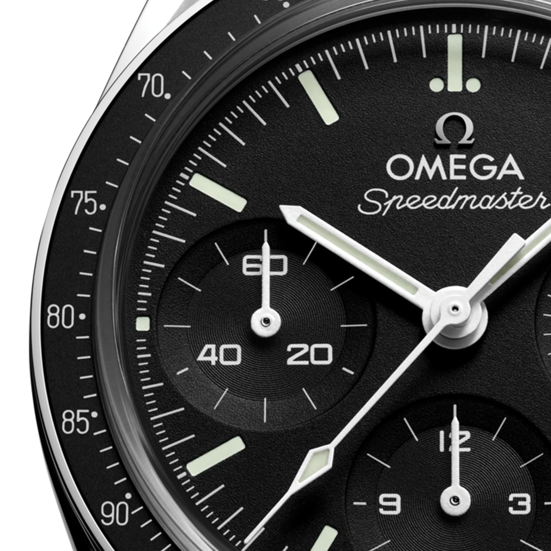 Close-up of an OMEGA Speedmaster 38 Co-Axial Chronometer Chronograph 38mm Watch with a black face, white indices, hands, and a tachymeter scale on the bezel.