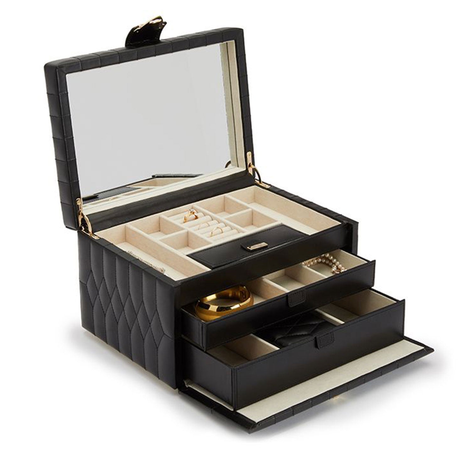 The WOLF 1834 Caroline Black Jewellery Box is open, revealing a luxurious diamond-quilted leather design. Inside, a large mirror and various compartments display rings, earrings, and other jewelry items, while two drawers below hold additional treasures like a gold watch and pearls.