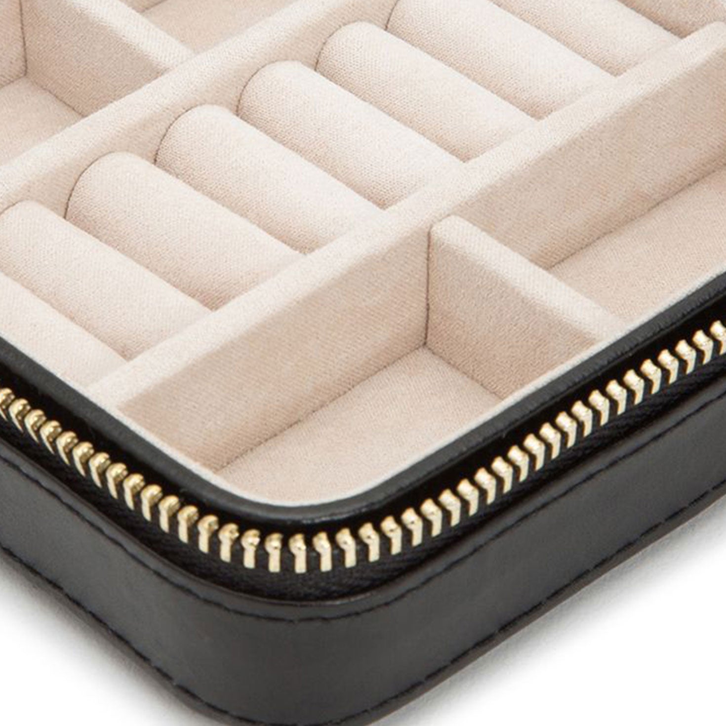 Close-up of an open WOLF 1834 Caroline Zip Travel Case with a beige interior. The diamond quilted leather compartments are designed for organizing rings and other small items, featuring a gold-colored zipper along the edges for secure closure.