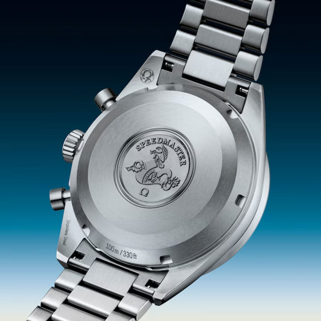 Close-up of the OMEGA Speedmaster Pilot Co-Axial Master Chronometer 40.85mm’s back with stainless steel bracelet, engraved Speedmaster logo and seahorse, marking its iconic flight heritage and 100m/330ft water resistance.