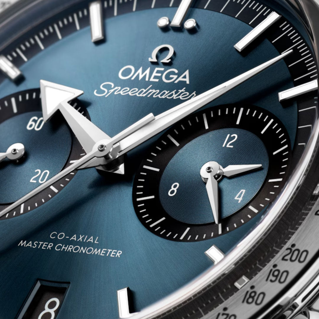 Close-up of the OMEGA Speedmaster 57 Co-Axial Master Chronometer Chronograph 40.5mm watch face, showing blue dial, silver hands, white hour markers, chronograph dials, and the OMEGA logo with “Co-Axial Master Chronometer” text.