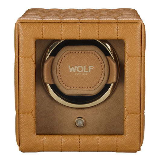 The WOLF 1834 Lauren Single Watch Winder Carmel features a sophisticated tan leather exterior with a quilted square design, a clear front window, and gold “WOLF” branding on the interior pad. Inspired by classic British roadster style, this watch winder seamlessly blends timeless elegance with modern sophistication.