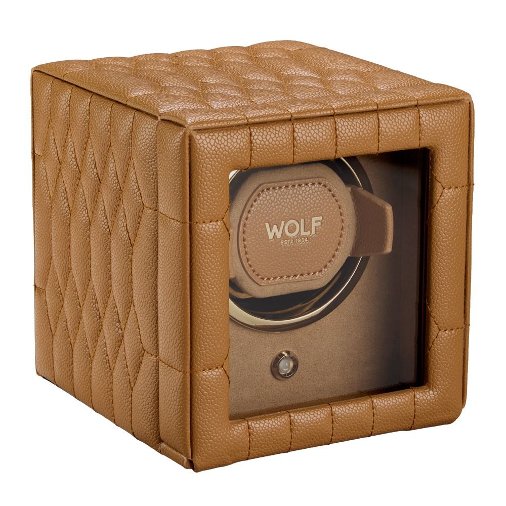 The WOLF 1834 Lauren Single Watch Winder Carmel features tan quilted leather inspired by classic British roadsters, with a clear front window showcasing a single watch holder labeled “WOLF.”.