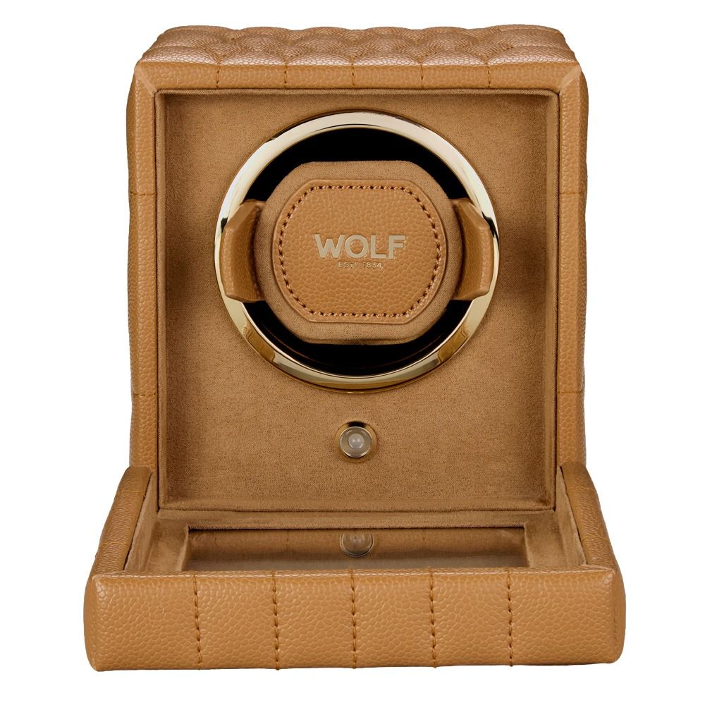 Introducing the WOLF 1834 Lauren Single Watch Winder Carmel: a tan leather watch winder box with elegant quilted texture and gold accents. The interior features the word “WOLF,” visible when the front panel is open to reveal the circular watch holder inside. Subtle ebony macassar wood detailing enhances its sophisticated, British roadster-inspired design.