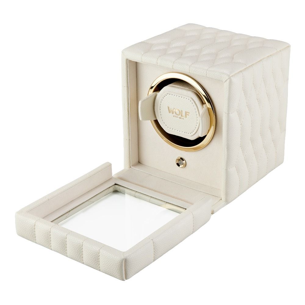 The WOLF 1834 Lauren Single Watch Winder Ivory features a cream-hued, quilted exterior with chrome hardware, a gold-accented circular holder inside, an open glass-front door, and the “WOLF” branding on the interior strap.