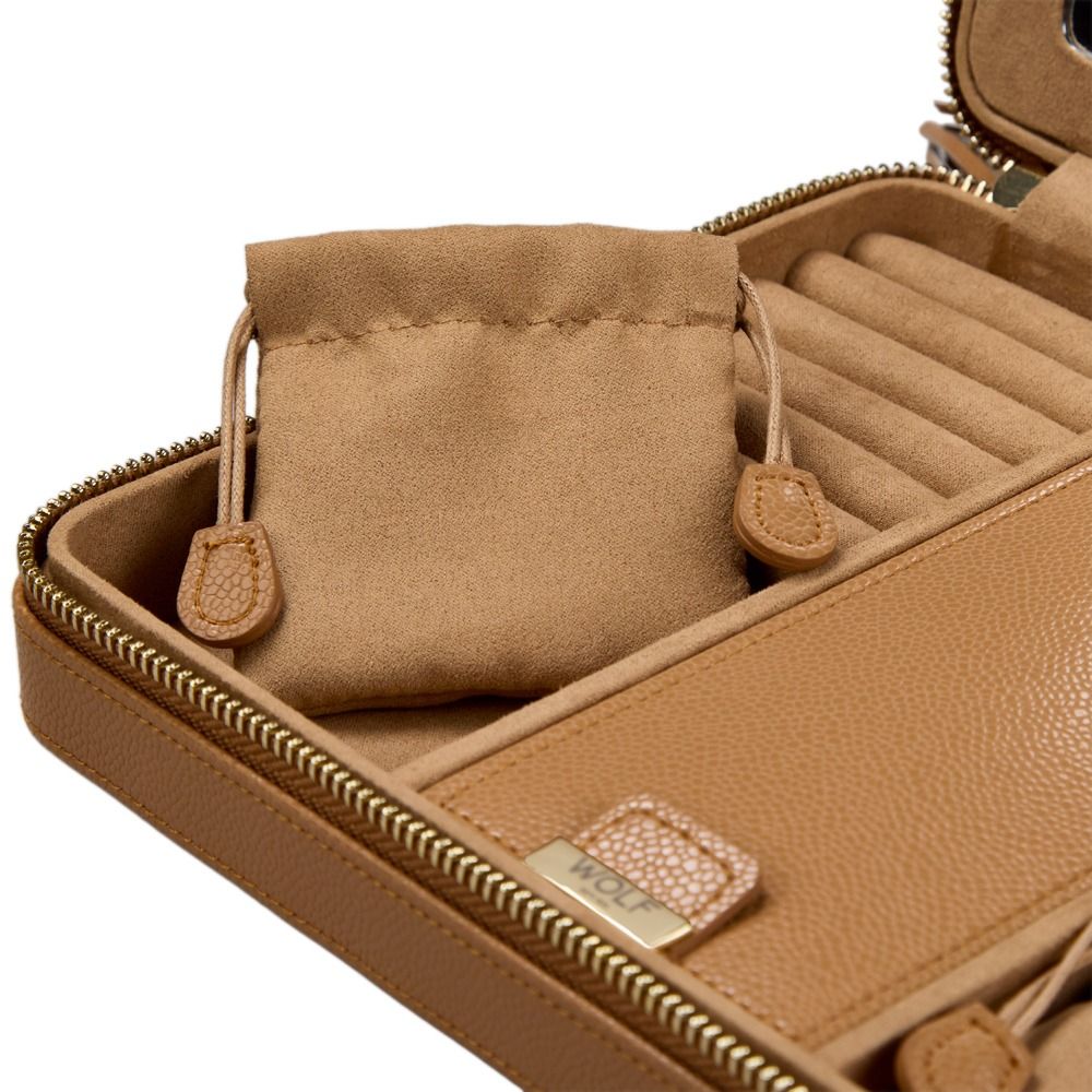 A close-up of the WOLF 1834 Lauren Large Zip Case Carmel by WOLF showcases its tan leather exterior, soft drawstring pouch, and thoughtfully designed compartments for organizing jewelry—an ideal anti-tarnish jewelry box for travel or everyday use.