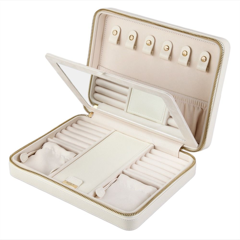 Introducing the WOLF 1834 Lauren Large Zip Case in Ivory by WOLF—a sophisticated white leather jewelry organizer featuring a secure zipper closure. The interior is thoughtfully designed with a soft lining, mirror, ring slots, necklace hooks, and multiple compartments to keep your accessories protected and neatly arranged. Perfect as a travel jewelry case, it ensures your valuables remain organized and secure wherever you go.
