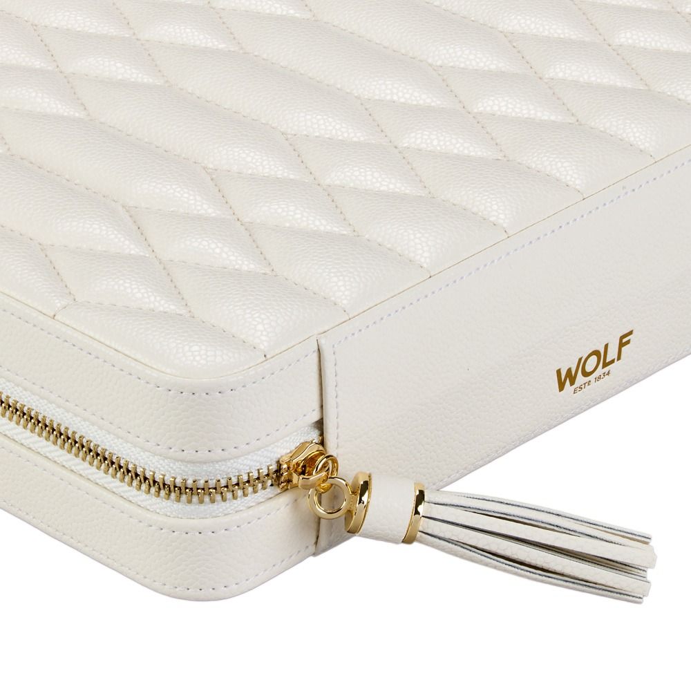Close-up of the WOLF 1834 Lauren Large Zip Case in ivory, crafted from white quilted leather with a gold zipper and finished with a white leather tassel. The bottom right corner is embossed in gold with “WOLF ESTD 1834,” making this elegant travel jewellery organizer perfect for keeping your treasures secure and organized on the go.