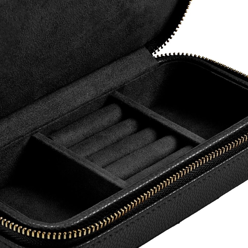 A close-up of an open WOLF 1834 Lauren Med Jewellery Box Black reveals a soft, velvet-like interior with several cushioned slots and compartments, perfect for storing watches or jewelry. Featuring WOLF’s LusterLoc™ technology, this elegant jewellery box helps protect and maintain your valuables wherever you go.