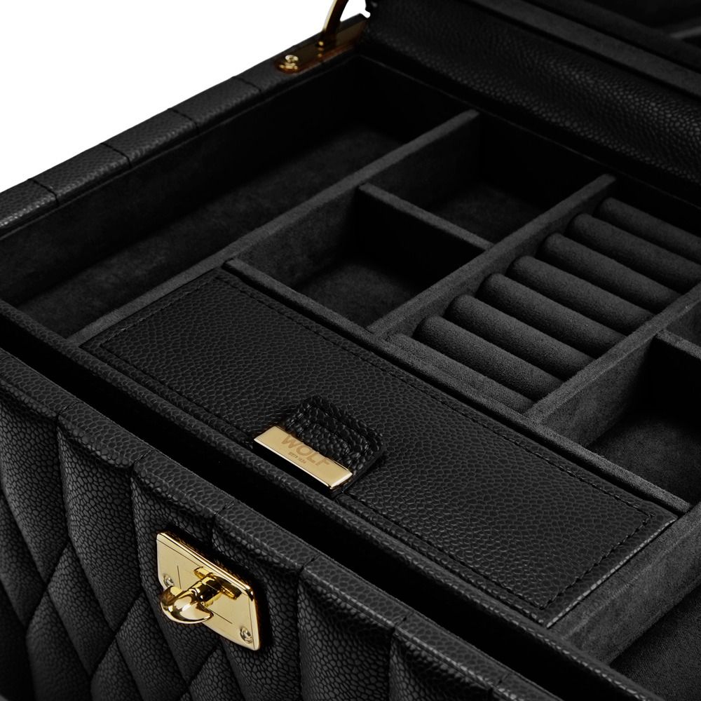 A close-up of the WOLF 1834 Lauren Medium Jewellery Box in black, featuring quilted leather and gold hardware, open to reveal multiple compartments lined with soft LusterLoc™ material for storing rings and other jewelry.