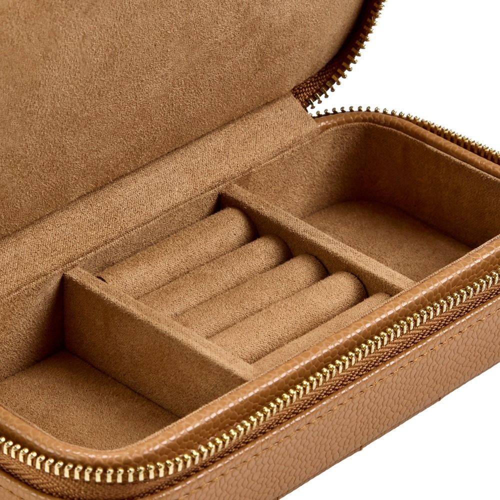 Introducing the WOLF 1834 Lauren Med Jewellery Box in Carmel by WOLF—a sophisticated jewelry case crafted from rich brown leather with a secure zipper closure. Designed with multiple compartments and padded slots for rings or small accessories, this jewelry box features a soft, suede-like interior lining that offers anti-tarnish protection, making it the perfect choice for keeping your treasures organized and pristine.