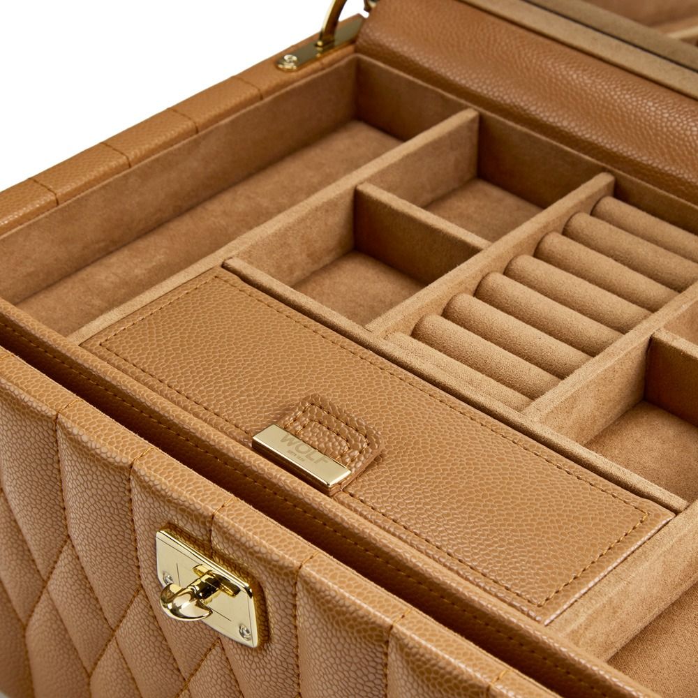 The WOLF 1834 Lauren Med Jewellery Box Carmel by WOLF features an open tan leather exterior with a quilted design, a gold clasp, and multiple compartments inside—including ring rolls and small sections for organizing your jewelry. This elegant travel case offers stylish and practical anti-tarnish storage to keep your collection secure and shining.