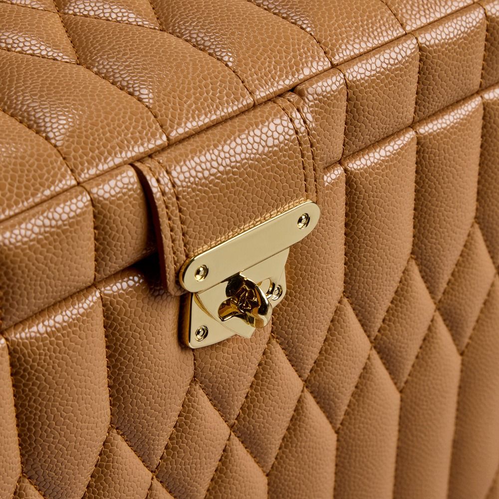 Close-up of the WOLF 1834 Lauren Med Jewellery Box Carmel—a quilted brown leather jewelry case by WOLF featuring a gold-toned metal clasp. The textured leather and precisely stitched geometric pattern lend this anti-tarnish jewelry box both elegance and practicality.