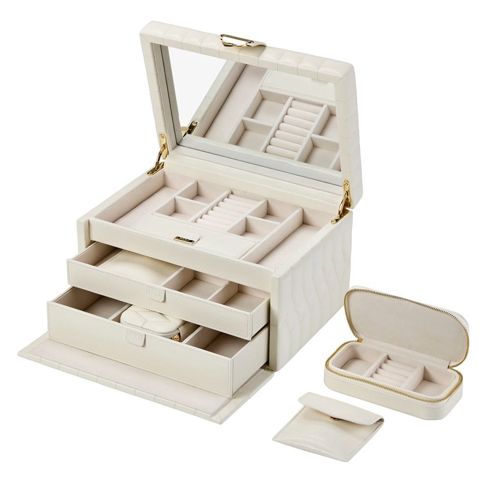 The WOLF 1834 Lauren Med Jewellery Box in Ivory is a white leather jewelry case featuring a mirror, multiple compartments, and two pull-out drawers, shown here with the matching Marrakesh Travel Case and small pouch by WOLF—each thoughtfully designed for anti-tarnish jewelry storage.