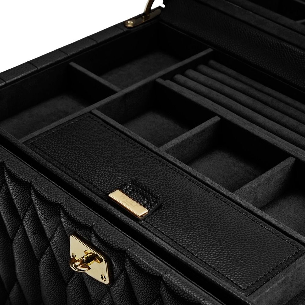 Here’s a rewritten version using your product data: Close-up of the WOLF 1834 Lauren Large Jewellery Box Black by WOLF, crafted from black diamond-quilted leather. The box features multiple compartments—including ring slots—and a gold latch, shown partially open to reveal its organized, tarnish-resistant interior.