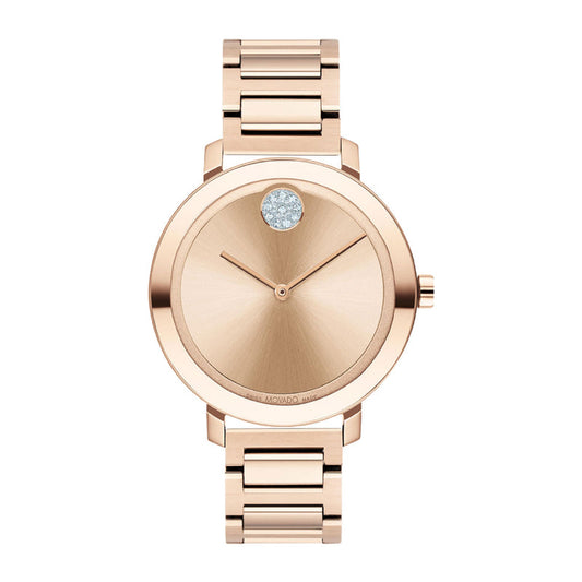 The Movado BOLD Evolution Quartz 34mm Watch by Movado features an elegant, minimalist design in exquisite rose gold. Its round face, accented by a single diamond at the 12 o'clock position, harmonizes beautifully with the coordinating rose gold metal band, making it a classic accessory that radiates sophistication.