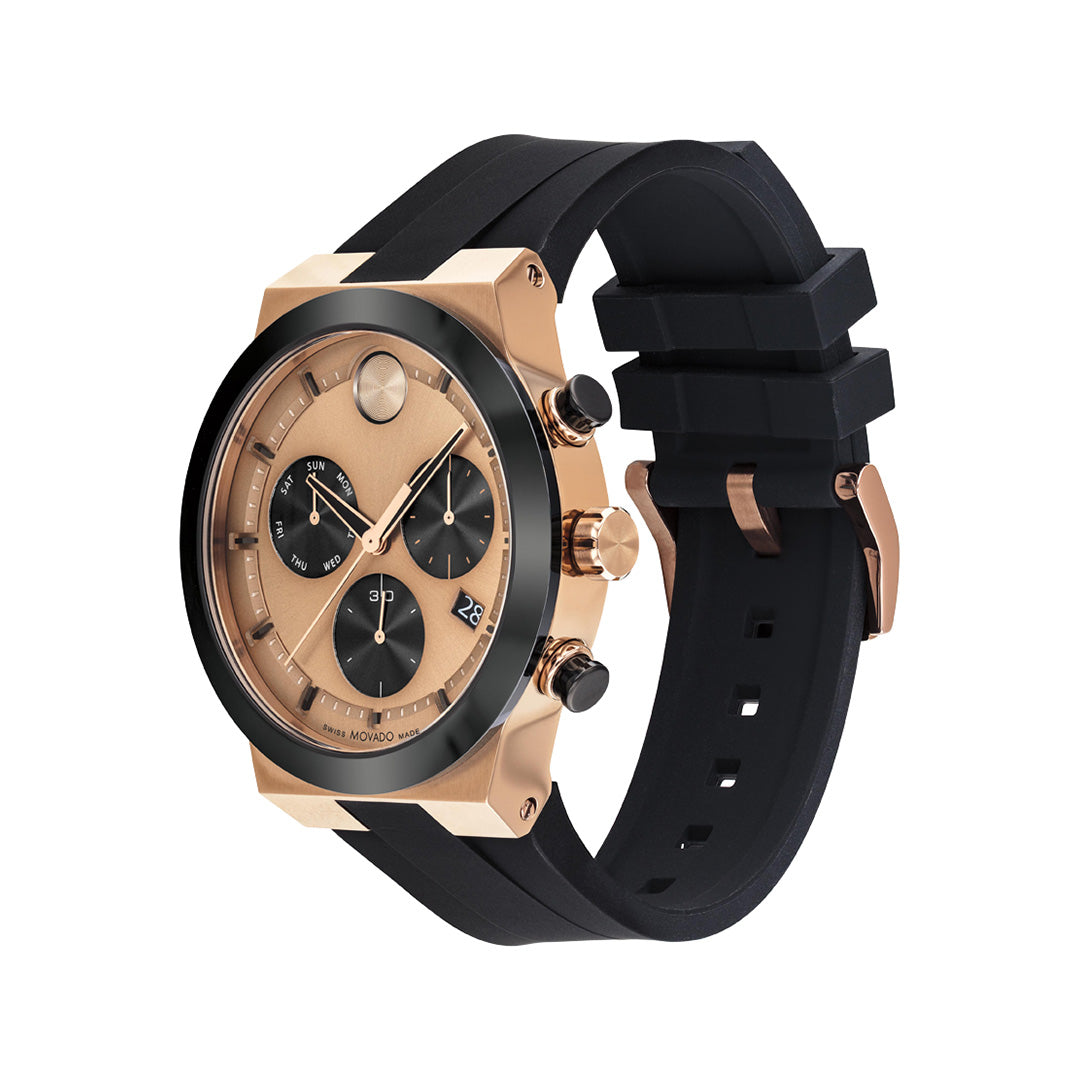 Movado BOLD Fusion Quartz Chronograph 44.5mm Watch with a metallic rose gold dial, three sub-dials, a date window, a black bezel, and a black silicone strap.