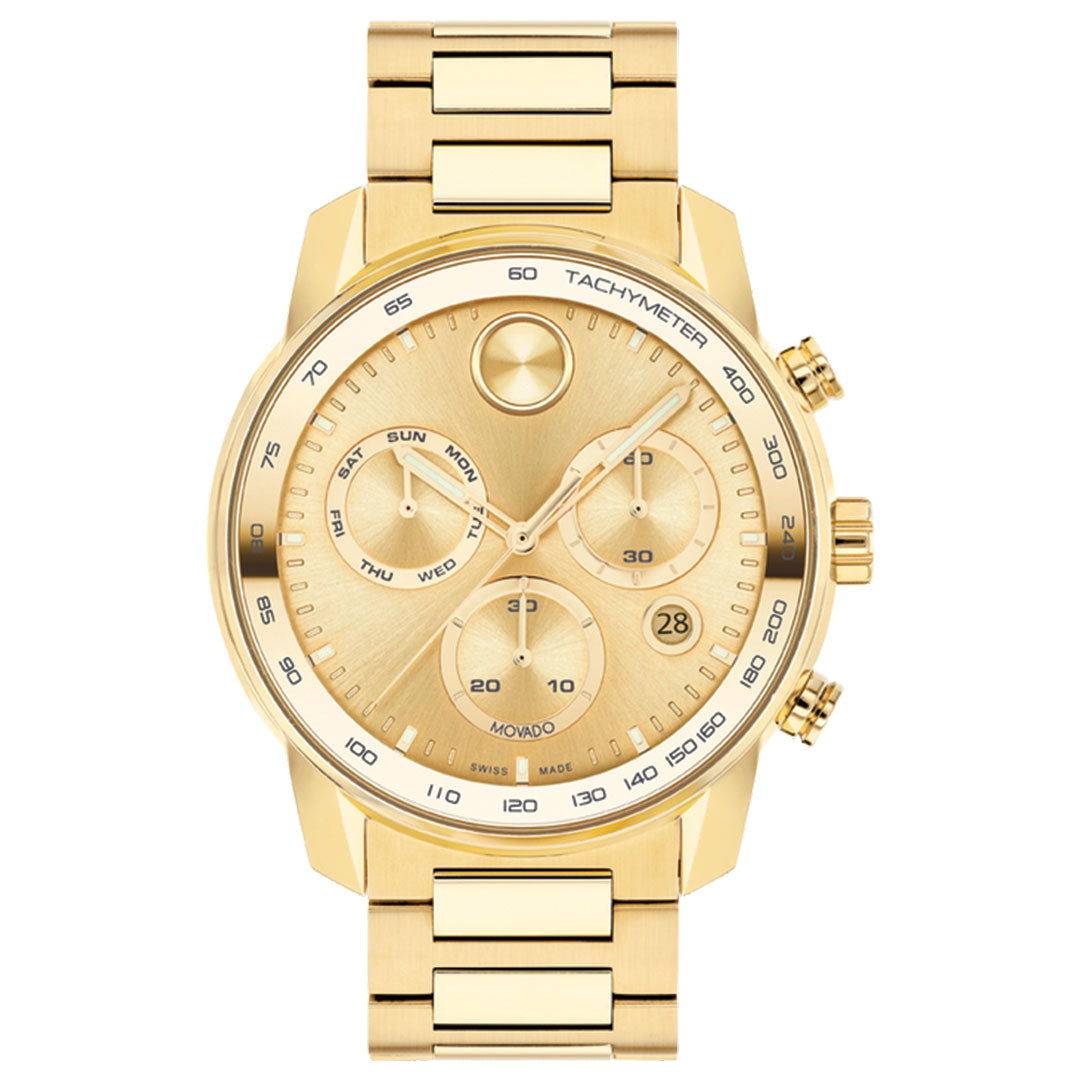 The Movado BOLD Verso Chronograph Quartz 44mm Watch features a gold-toned stainless steel band and face, three subdials for day, date, and 24-hour time, a tachymeter bezel, and two side buttons. Brand: Movado.