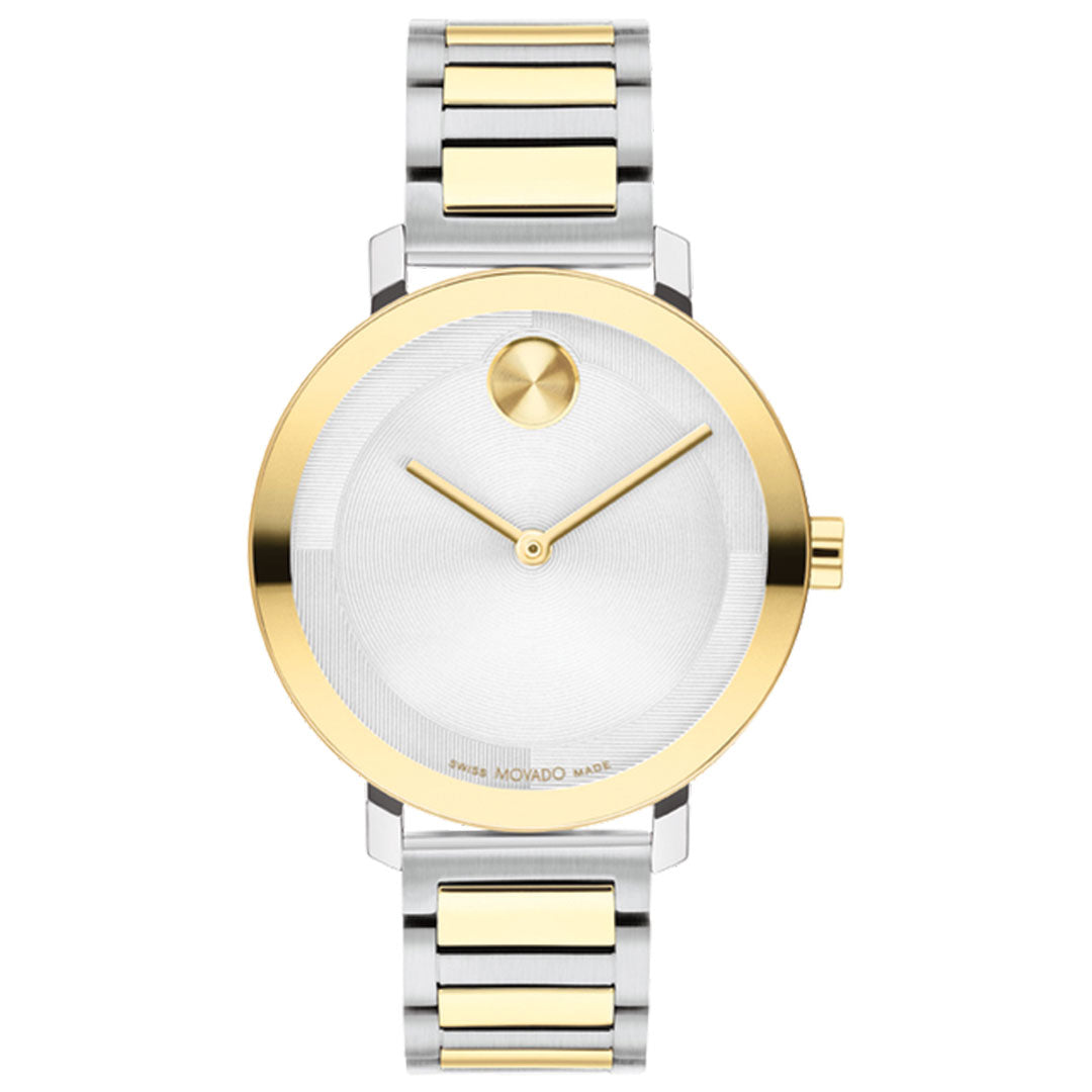 The Movado BOLD Evolution 2.0 Quartz 34mm Watch features a chic silver and gold stainless steel bracelet, minimalist white dial with a gold bezel, signature single dot at 12 o’clock, and two gold hands for an elegant look.
