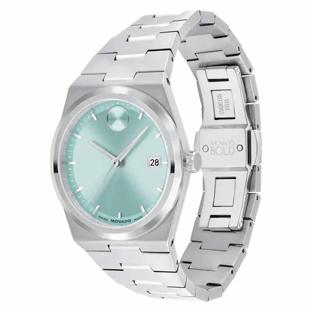 The Movado BOLD Quest Quartz 35mm watch is a stylish silver wristwatch with stainless steel hands and a seafoam blue sunray dial featuring a date display. It boasts a sleek metal band and minimalist design, with the "Movado" brand name prominently on the clasp.
