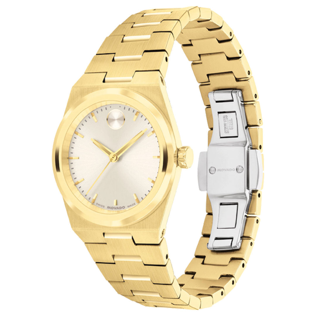 The Movado BOLD Quest Mini Quartz 28mm Watch features a gold metallic band, minimalist champagne dial without numbers, a single dot at 12 o’clock, and a silver clasp engraved with the Movado brand name.