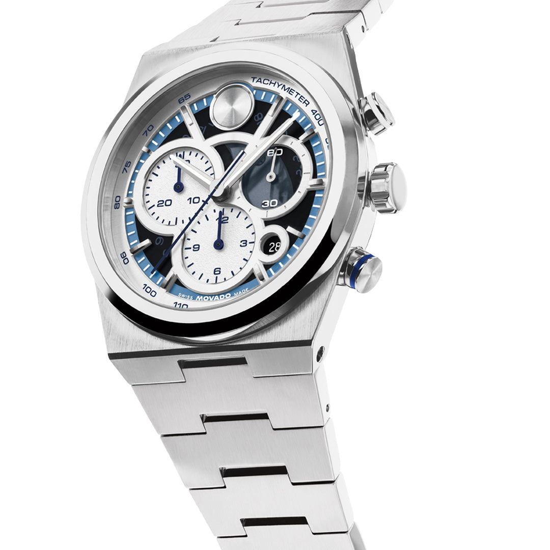 The Movado BOLD Quest Chronograph Quartz 40mm Watch by Movado showcases a Swiss chronograph movement with a stainless steel bracelet, complemented by a striking silver and blue dial, three subdials, a date window, and a tachymeter bezel for precise timekeeping—all presented in an elegant and contemporary design.