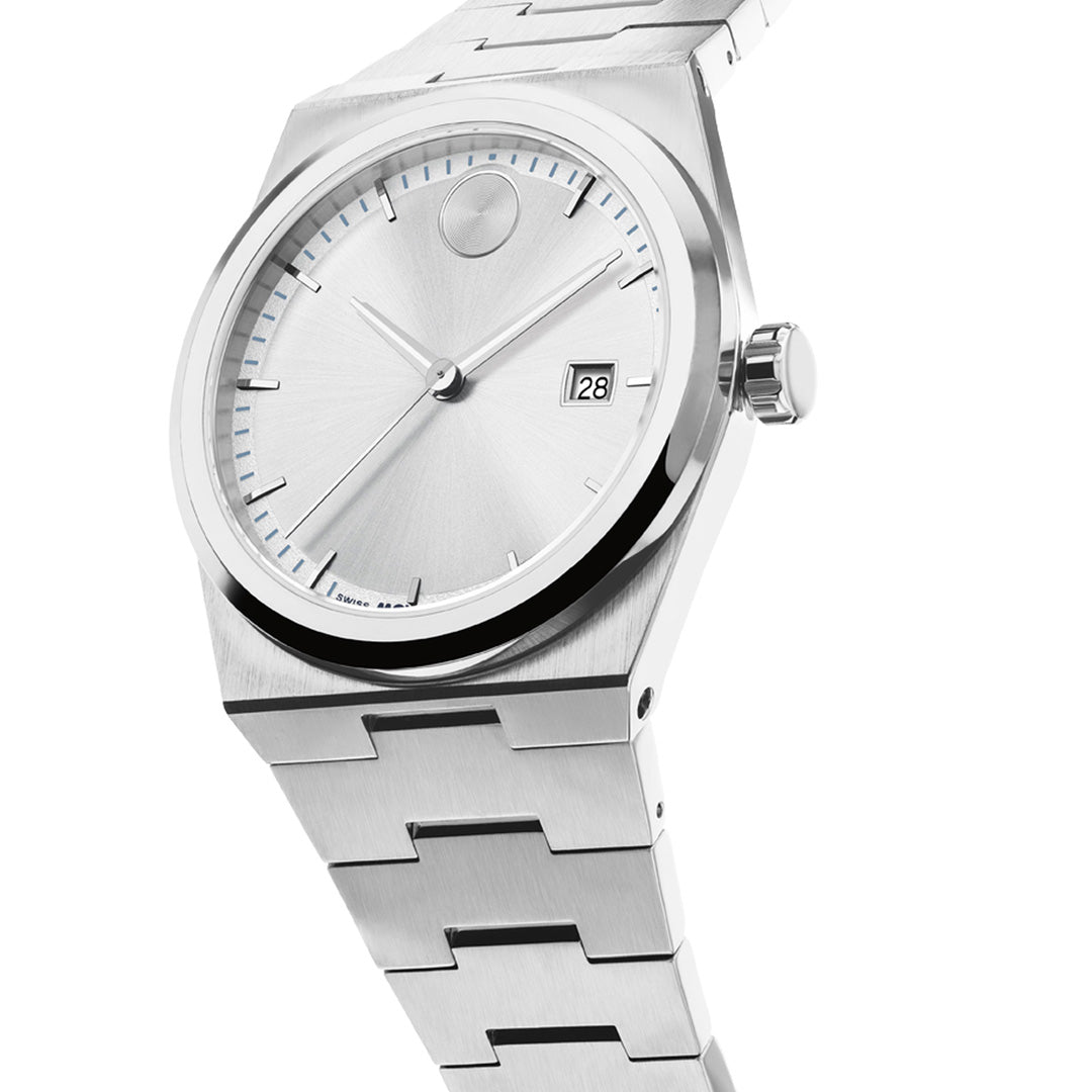 The Movado BOLD Quest Quartz 40mm Watch by Movado, featuring a brushed silver metal face with a minimalist design, date display at 3 o’clock, and a linked stainless steel band, is photographed at an angle against a white background. This Swiss-made timepiece showcases precision quartz movement within its refined casing.