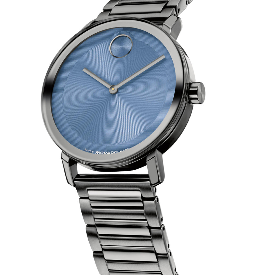 Introducing the Movado BOLD Evolution 2.0 Quartz 40mm Watch by Movado—a sleek, modern timepiece featuring a segmented silver metal link band and a blue, minimalist dial adorned only with silver hour and minute hands and a single dot at the 12 o’clock position. The micro-textured face enhances its subtle sophistication, epitomizing contemporary design.