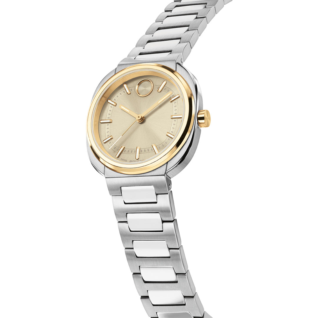 Movado BOLD Nuvo Quartz 30mm X 31mm watch featuring a two-tone stainless steel cushion case, a silver-colored link bracelet, a round yellow gold ion-plated bezel, and a champagne dial with a signature dot at the twelve o’clock position.