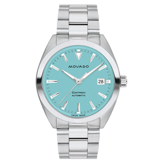 The Movado BOLD Heritage Series Datron Automatic 40mm Watch by Movado boasts a turquoise face adorned with silver markers, exuding a retro-cool design. Its Swiss-made automatic movement ensures precision and includes a date display at 3 o'clock. Complementing its white backdrop, the stainless steel bracelet enhances the watch's sleek and modern aesthetic.