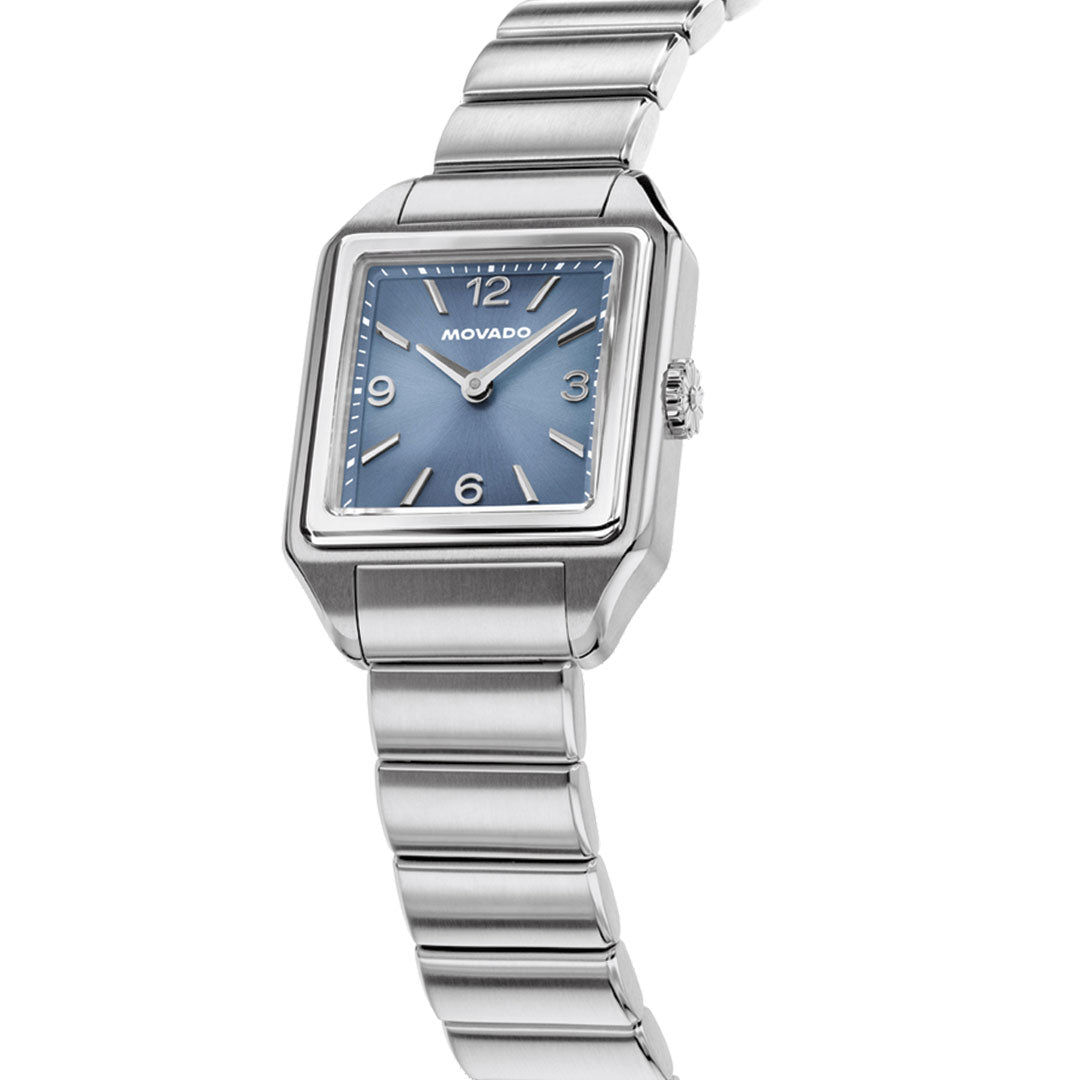 The Movado Heritage 1917 Quartz 25mm x 34.10mm watch features a silver-tone stainless steel case, blue dial, and link band, shown at an angle on a white background.