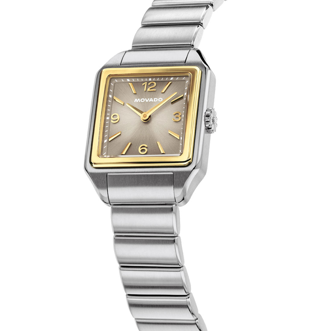 The Movado Heritage 1917 Quartz 25mm x 34.10mm watch features a square stainless steel case in silver and gold tones, gold hour markers and hands, and a silver metal link band, displayed at an angle on a white background.