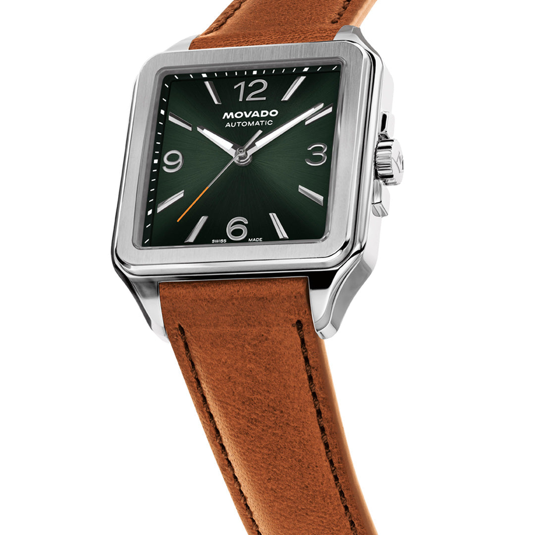 The Movado Heritage 1917 Automatic 44.6mm x 35mm Watch by Movado is showcased at an angle on a white background, featuring a square stainless steel case, green dial with silver hour markers, and a brown leather strap. This Art Deco-inspired timepiece effortlessly combines vintage charm with modern sophistication.