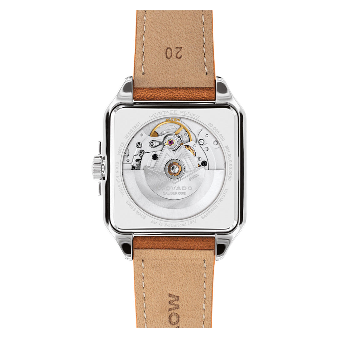 The Movado Heritage 1917 Automatic 44.6mm x 35mm Watch features a square case with a transparent back that reveals the intricate internal gears and mechanisms. This Swiss made timepiece comes with a brown leather strap embossed with “20” and “MOVADO”, and its back is inscribed with “HERITAGE SERIES,” highlighting its legacy in the Movado collection.