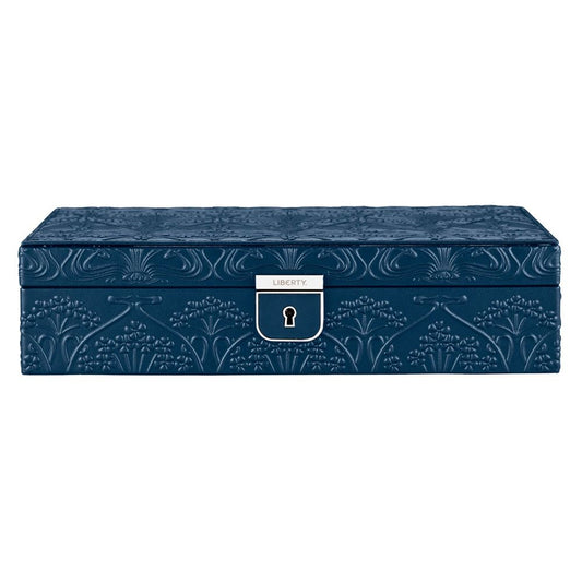 A rectangular navy jewellery box from WOLF, crafted in leather embossed with the Liberty All Over Ianthe floral pattern and finished with a silver clasp bearing the “LIBERTY” label on the front.