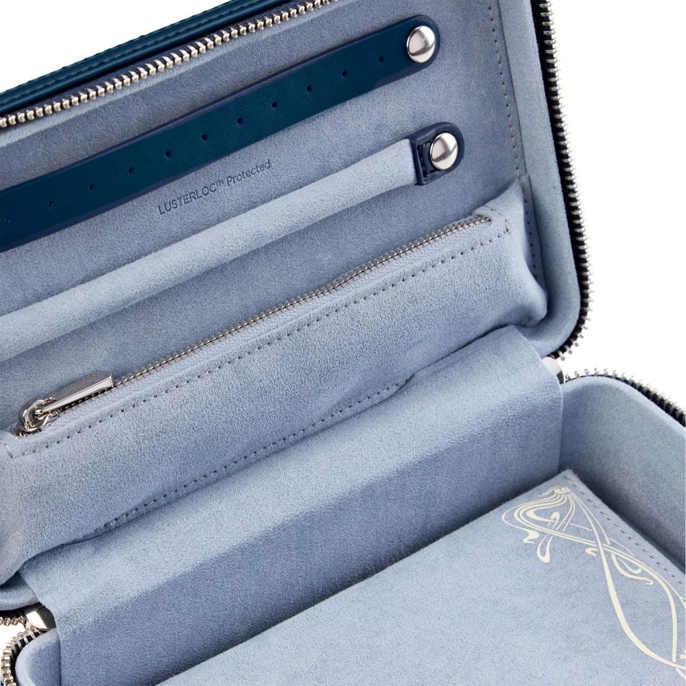 Introducing the WOLF 1834 X Liberty All Over Ianthe Medium Jewellery Zip Case in Navy—a sophisticated leather organizer featuring a soft suede interior, zippered pocket, dedicated jewelry slots, and a secure strap with metal snaps. This elegant travel jewelry case by WOLF is accented with a decorative cream-colored detail.