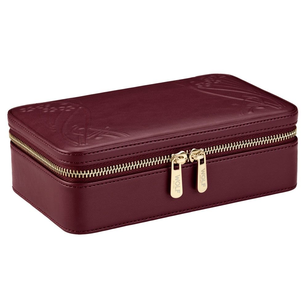 The WOLF 1834 X Liberty All Over Ianthe Medium Jewellery Zip Case in Burgundy is a rectangular maroon leather organizer featuring subtle embossed designs and elegant gold dual zippers, shown closed against a white background—a stylish travel jewelry case by WOLF that keeps your accessories protected and organized.