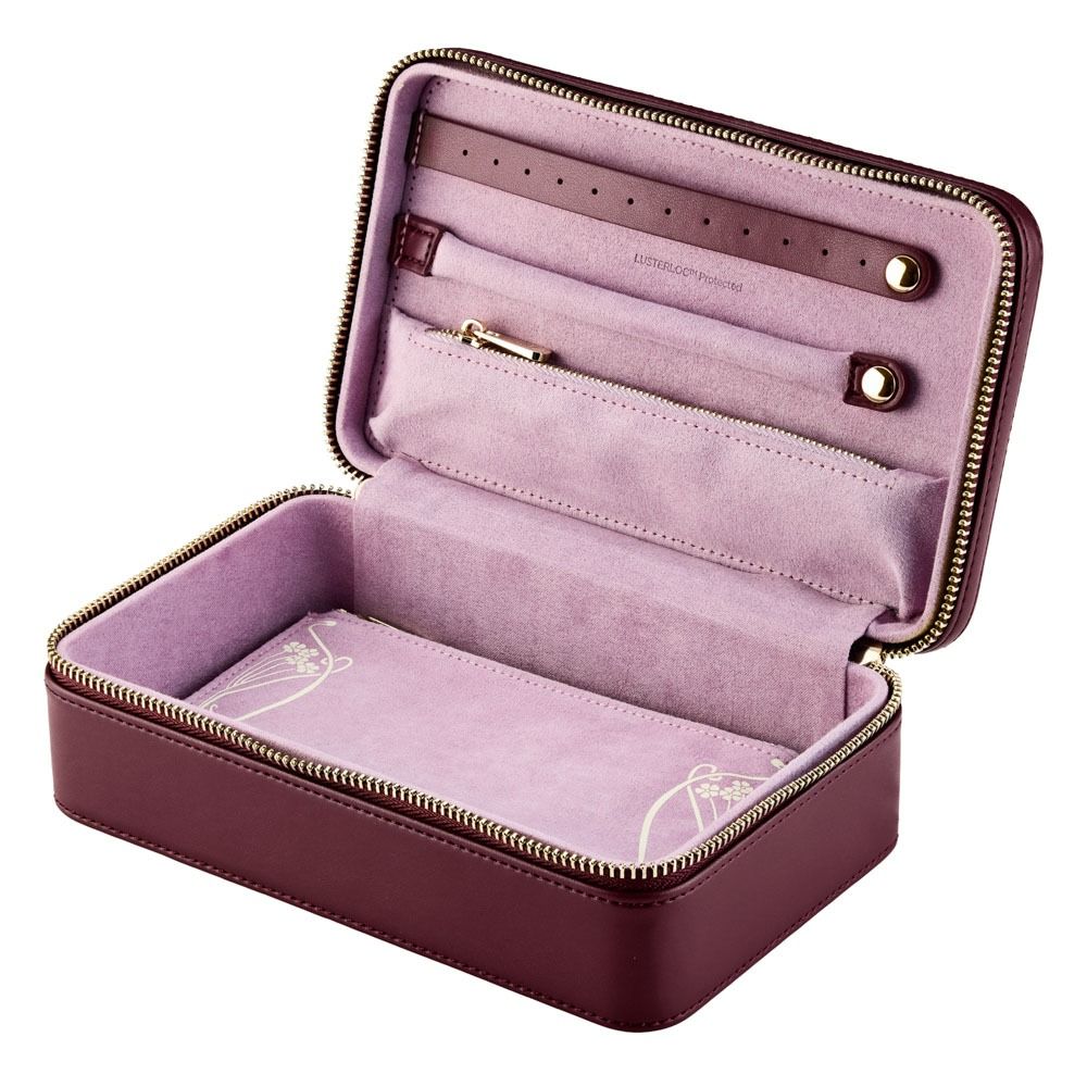 The WOLF 1834 X Liberty All Over Ianthe Medium Jewellery Zip Case in Burgundy is a rectangular, maroon leather travel jewelry organizer featuring a gold zipper. When opened, it reveals a soft, light pink interior with compartments and straps designed to keep your valuables secure and tangle-free on the go.