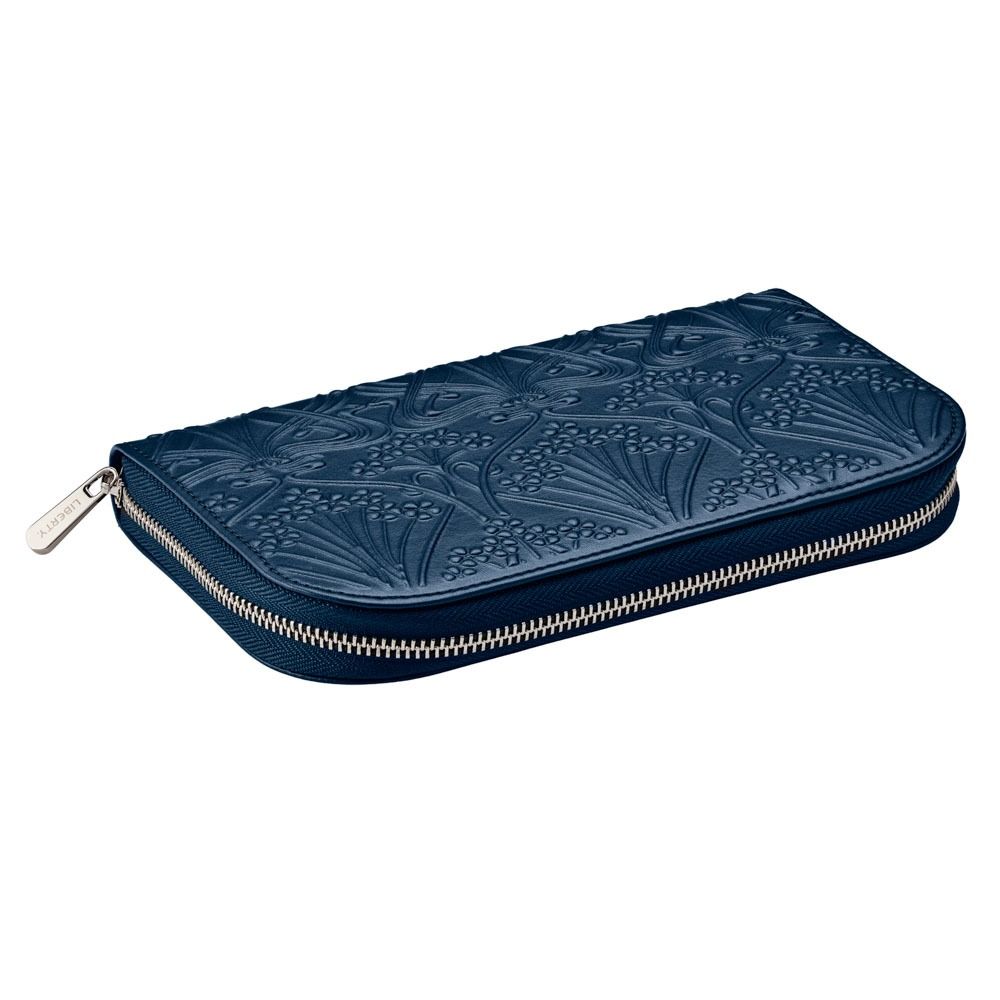 The WOLF 1834 X Liberty All Over Ianthe Travel Jewellery Portfolio in navy is a stylish zippered wallet featuring an embossed floral pattern and a silver zipper pull, crafted by WOLF with a soft LusterLoc™ interior to protect your treasures while traveling.