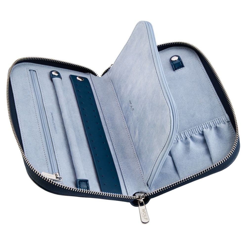 The WOLF 1834 X Liberty All Over Ianthe Travel Jewellery Portfolio Navy, by WOLF, is a zippered blue suede travel case featuring multiple compartments for watches and accessories, including slots, elastic holders, and a flap divider lined with a protective LusterLoc interior. It is shown open on a white background.